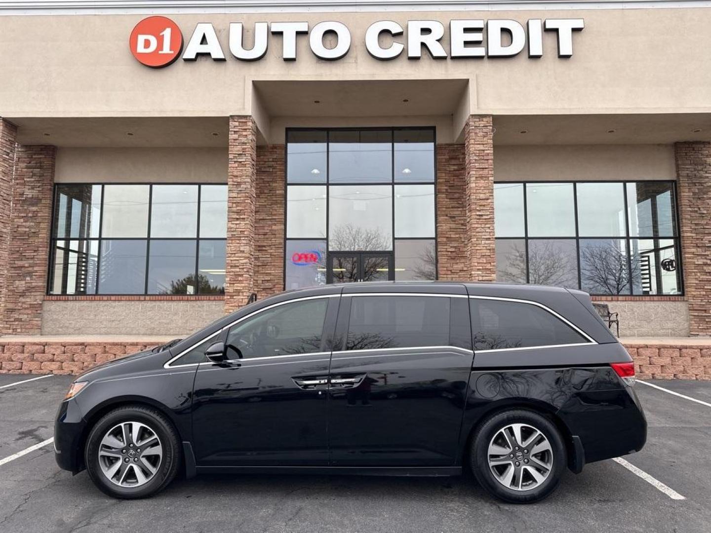 2015 Crystal Black Pearl /Gray Honda Odyssey Touring (5FNRL5H97FB) with an 3.5L V6 SOHC i-VTEC 24V engine, Automatic transmission, located at 8595 Washington St., Thornton, CO, 80229, (303) 287-5511, 39.852348, -104.978447 - Tons of schedule maintanence done on CARFAX (free on our website d1autocredit.com) including timing belt in 2022. This van is a non smoker, non pet and it even looks like it never had kids in it! Clean Title.<br><br>Completley loaded with everything including DVD player with headphones, heated leath - Photo#0
