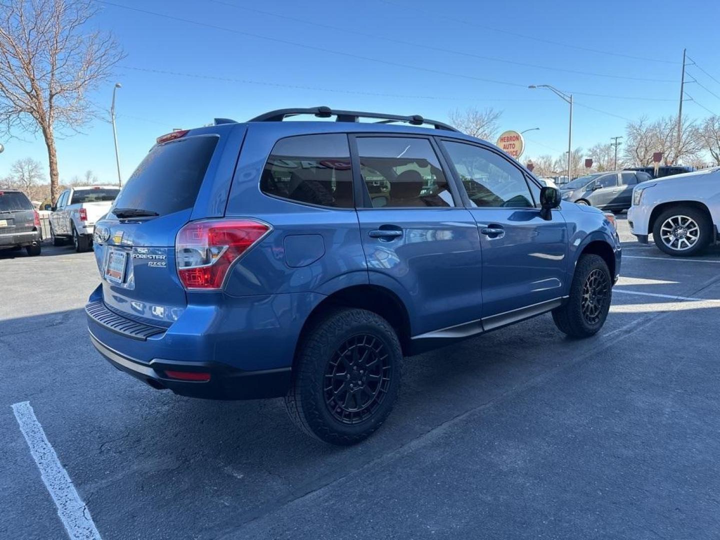 2016 Quartz Blue Pearl /Gray Subaru Forester 2.5i Premium (JF2SJAFC1GH) with an 2.5L 4-Cylinder DOHC 16V VVT engine, CVT transmission, located at 8595 Washington St., Thornton, CO, 80229, (303) 287-5511, 39.852348, -104.978447 - 2016 Subaru Forester Clean Carfax, No Accident, 2 inch lift with New Tires, Backup Camera, Heated Seats, Bluetooth/ With Bluetooth Audio, LIFTED!, AWD. <br><br>D1 Auto NEVER charges dealer fees! All cars have clean titles and have been inspected for mechanical issues. We have financing for everyone. - Photo#5