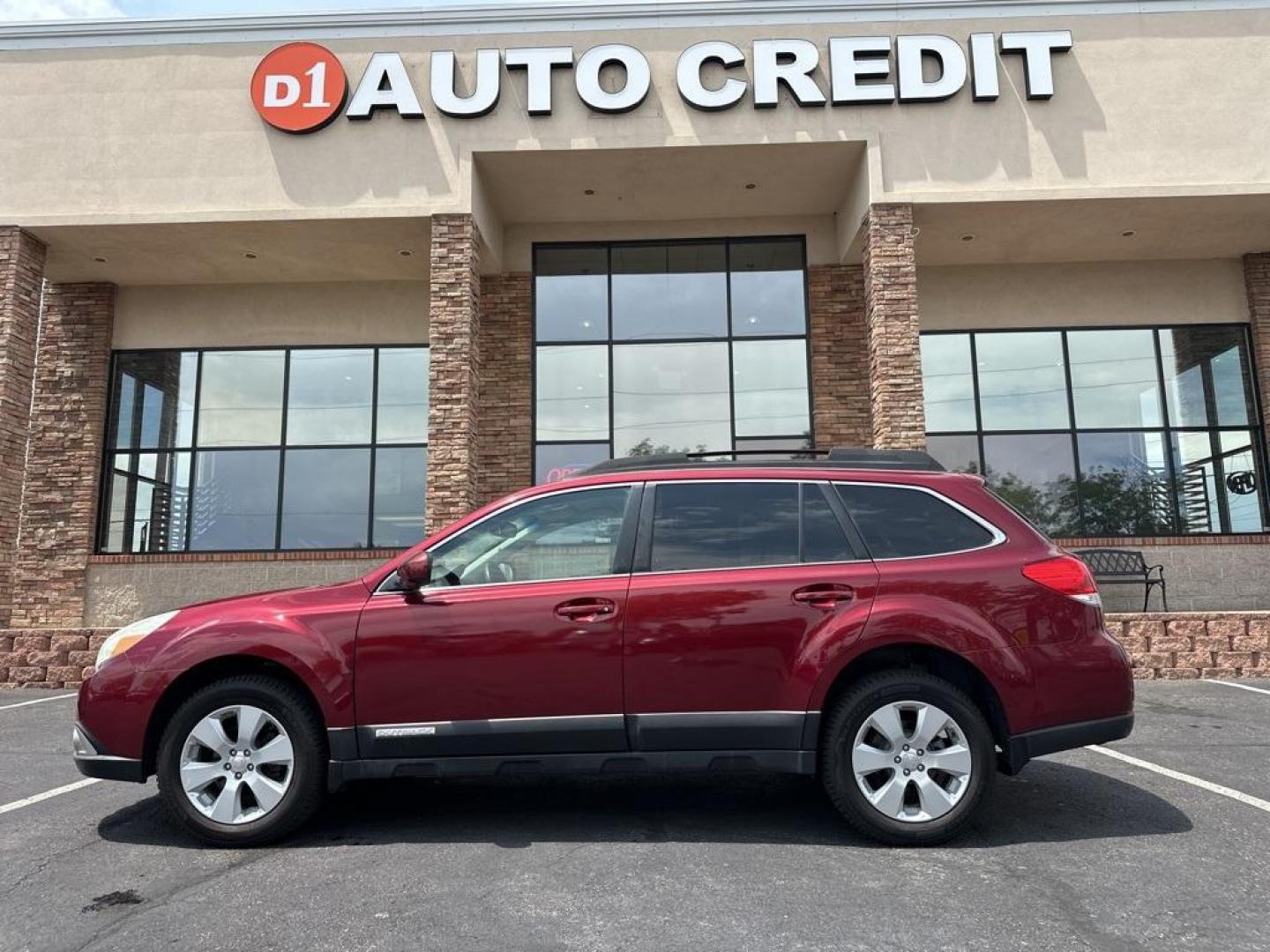 2011 Ruby Red Pearl /Ivory Subaru Outback 2.5i Premium (4S4BRBFC8B3) with an 2.5L 4-Cylinder engine, CVT transmission, located at 8595 Washington St., Thornton, CO, 80229, (303) 287-5511, 39.852348, -104.978447 - 2011 Subaru Outback<br><br>D1 Auto NEVER charges dealer fees! All cars have clean titles and have been inspected for mechanical issues. We have financing for everyone. Good credit, bad credit, first time buyers.<br>CARFAX One-Owner. Clean CARFAX. Odometer is 4040 miles below market average!<br>Pleas - Photo#0